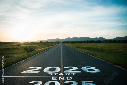Happy new year 2026,2026 symbolizes the start of the new year.word 2026,2025,2027 written on the road at sunset.Concept of planning and challenge,career path,business strategy,opportunity,start change
