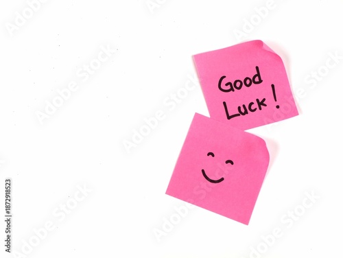 Bilde på lerret Pink sticky notes with good luck text and smiley face on white background