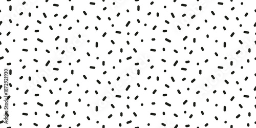 Seamless pattern of scattered small black dashes. Random tiny dash pattern.