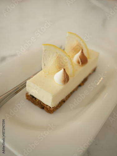 Minimal Lemon Cheesecake Slice on White Plate with Creamy Texture and Soft Natural Lighting