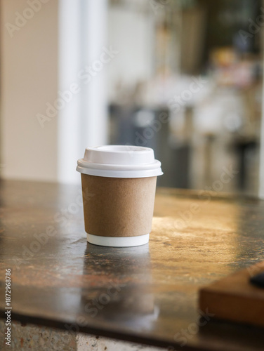 Minimalist Takeaway Coffee Cup on Rustic Café Counter with Soft Natural Light