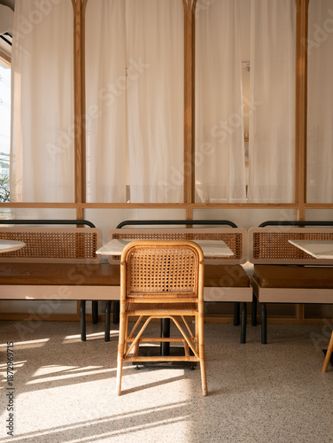 Minimalist Cafe Seating Area with Rattan Chair, Marble Table, and Soft Natural Daylight