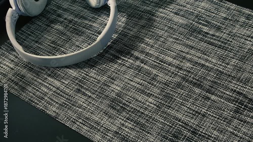 Taking headphones and sunglasses from the table in a cozy indoor setting during daylight