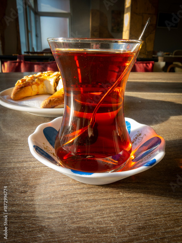 Traditional Turkish Tea Served in Glass with Pastry on Wooden Table