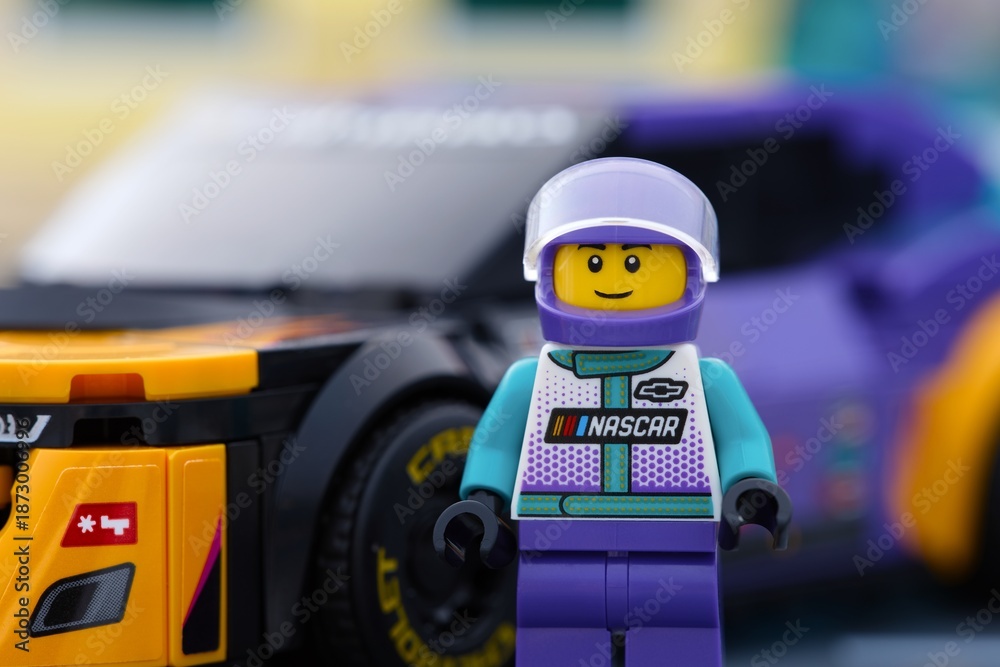 Obraz premium Tambov, Russian Federation - January 02, 2026 Portrait of a Lego NASCAR Next Gen Chevrolet Camaro ZL1 driver minifigure standing near his car. LEGO Speed Champions.