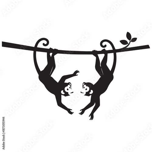 Two playful monkeys hanging upside down from a branch