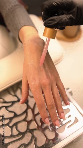 A manicurist does manicures in a beauty salon.