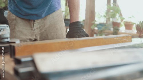 A worker is grinding rust off a steel part with an angle grinder. Close-up.