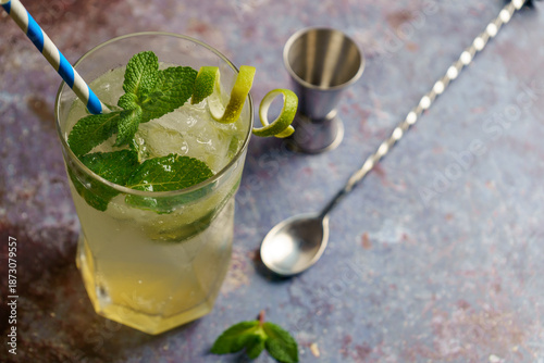 Refreshing iced Mojito cocktail or mocktail with lime, fresh mint, and ice. 