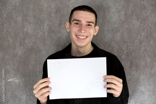 Young Man Holding Blank White Sign for Your Message