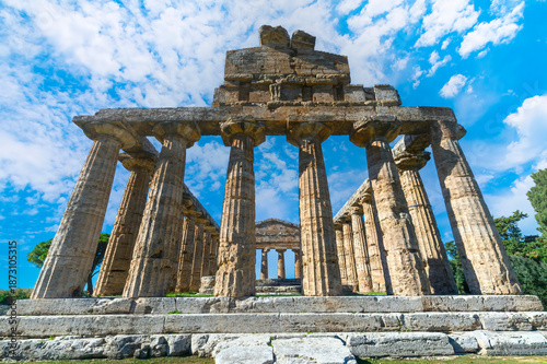 Ancient Greek Temple of Athena in Paestum, Italy at sunny day with blue sky. Famous archaeological site of Paestum, Magna Graecia, ancient ruins.