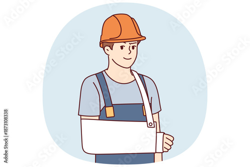 Man builder with broken arm after accident at workplace and looks at screen. Guy builder or foreman in hardhat and work overalls got injured during construction for employees insurance concept