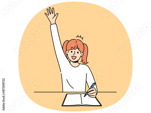 School girl sits at desk with workbook and pen and raises hand wanting to answer teacher question. Child from primary school enjoys process of learning and gaining new knowledge thanks to education