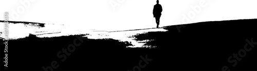 Silhouette of solitary figure walking on snowy landscape