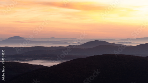Gradina viewpoint at mountain Zlatibor offering beautiful view of hilly rural landscape and valleys filled with fog at dawn, visit Serbia countryside, autumn season at October