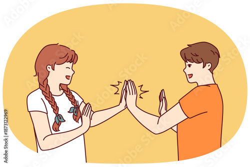 Children play hand-clapping laughing and enjoying teenage friendship and happy childhood. Boy and girl play hand-clapping after school for concept of children socialization through active games