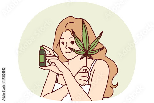 Woman uses hemp oil for skin care and fighting acne or wrinkles on face and holds marijuana leaf in hand. Girl recommends hemp cosmetic product for anti-aging, concept of weed for medical purposes