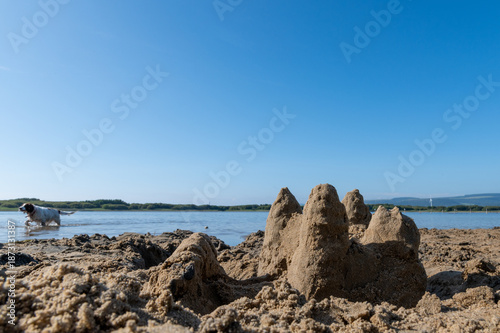 Sandcastle on.a beach with clear blue sky in the background