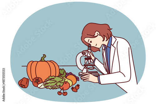 Checking quality of food in laboratory by woman using microscope to look for nitrates and pesticides. Girl scientist controls quality of products of grocery store and works in field of food technology