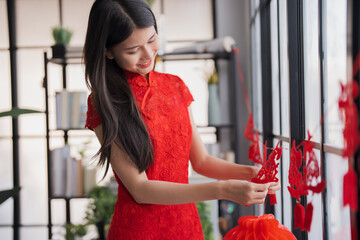 Beautiful young asian woman red clothes making paper craft red Chinese new year lantern for Lunar New Year decorations Chinese New Year Celebrations for good luck