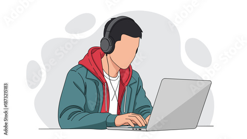 Young man wearing headphones working on laptop with focus