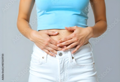 Wallpaper Mural Woman Experiencing Lower Abdominal Pain, Hands Pressing Crotch Area, Health and Wellness Concept Torontodigital.ca