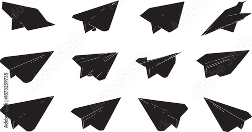 Twelve black paper airplane silhouettes in various orientations and angles on a white background