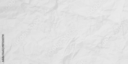 
​White crumpled paper texture background. Abstract, distressed, and wrinkled surface for a simple, minimal backdrop or overlay.