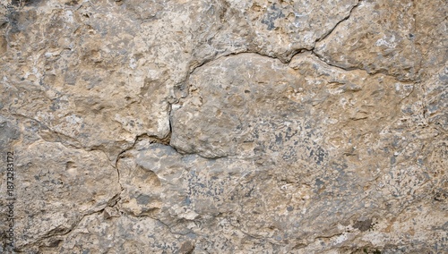 Natural Stone Wall With Various Textures and Colors in Urban Setting During D...