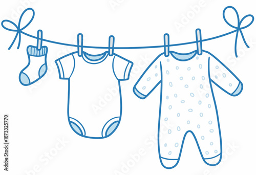 Blue baby clothes hanging a clothesline with clothespins and bows
