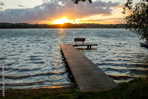 Canvas Print Sunset pier with bench at Jezioro Kłodno lake in Kashubia region, Poland