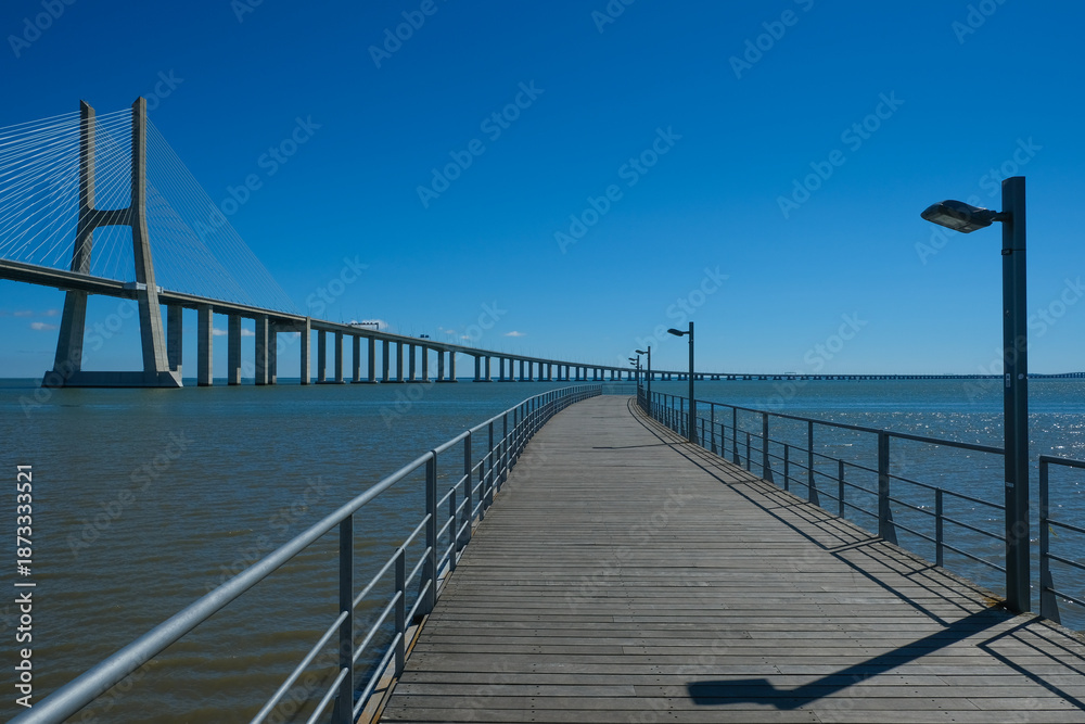 Fototapeta premium Vasco da Gama Bridge and Riverside Walkway at Parque das Nações in Lisbon
