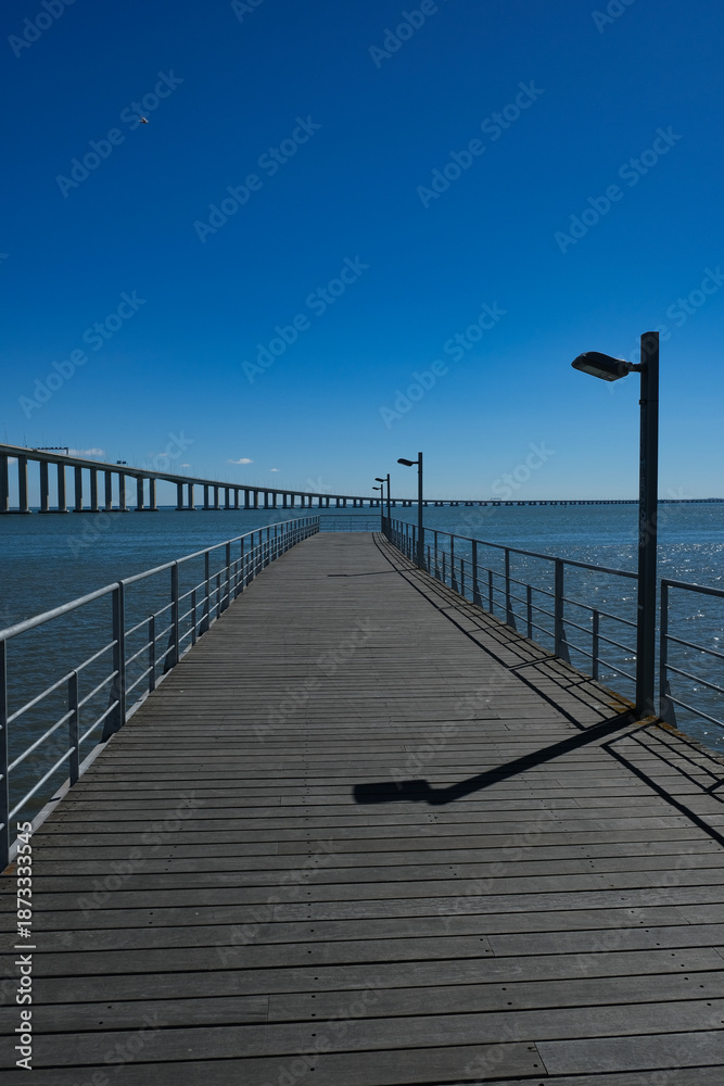 Fototapeta premium Vasco da Gama Bridge and Riverside Walkway at Parque das Nações in Lisbon