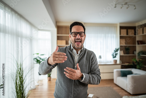 Photos Man wearing eyeglasses talking enthusiastically and gesturing indoors