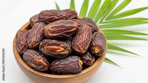 Wallpaper Mural Dried dates fill a wooden bowl with green palm leaves background. Torontodigital.ca