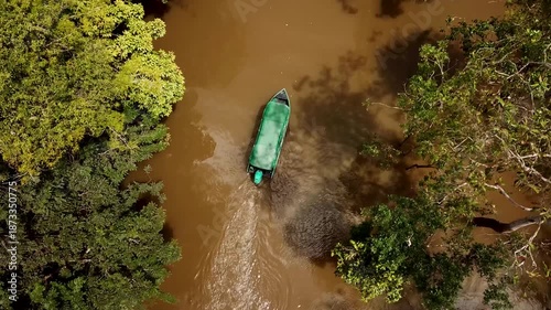 Boat cruising on the amazon river near Manaus with a lush nature, Brazil. Aerial drone footage. High quality 4k footage