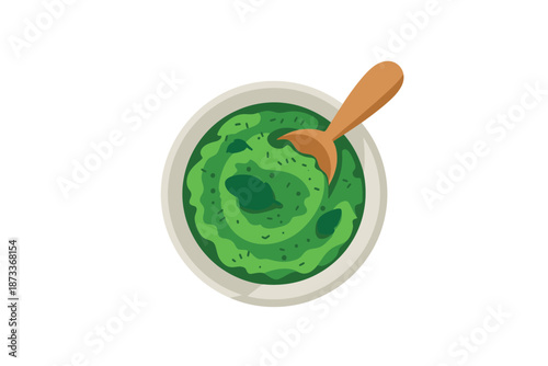 A vibrant green spinach soup in a white bowl with a wooden spoon