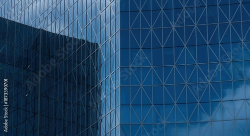 Tableau sur toile Modern office building with blue reflective glass exterior