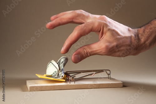 Valokuva Close-up of man's hand putting money into mousetrap