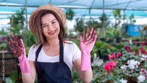 young woman florist in greenhouse
