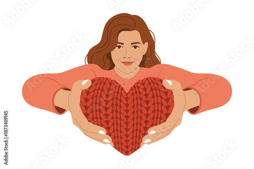 A woman holding a large red heart in her hands lovingly