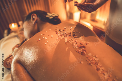 Canvastavla Woman customer having exfoliation treatment in luxury spa salon with warmth candle light ambient