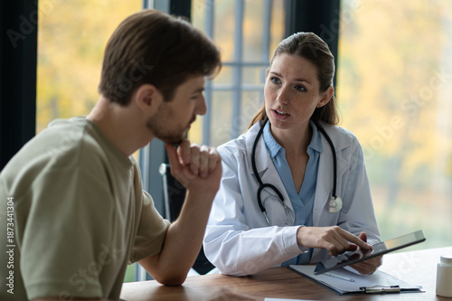Female doctor in a lab coat giving prescription to the patient