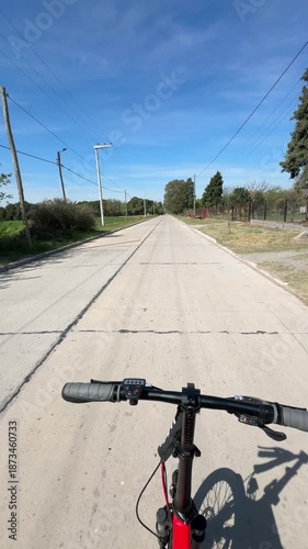 Vertical first-person video of riding a hands-free electric bicycle through the rural streets of Cordoba, Argentina