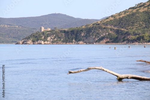 Beautiful scenic view of a wild and empty sandy beach in Albinia, Maremma region, Grosseto province, Tuscany, Italy. Blue sea and Mediterranean coastline under a clear sky.