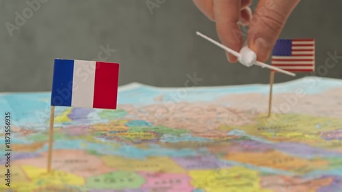 Toy airplane near United States and France flags on world map, symbol long haul routes, alliance hubs, tourism demand and competition in France transatlantic air travel market.