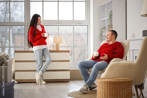 Young couple in warm red sw...