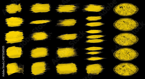 Abstract yellow brush strokes on black background, artistic texture elements.
