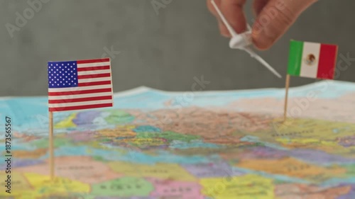 Toy airplane flying from Mexico to United States across political world map, symbol resort tourism, work travel, visiting relatives and busy North America air routes.