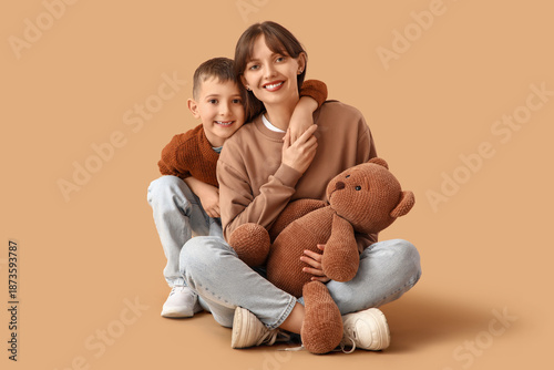 Happy mother with toy bear ...